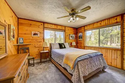 a bedroom with a bed and a ceiling fan at 4 Mi to Rocky Moutain Natl Park Grand Lake Home! in Grand Lake