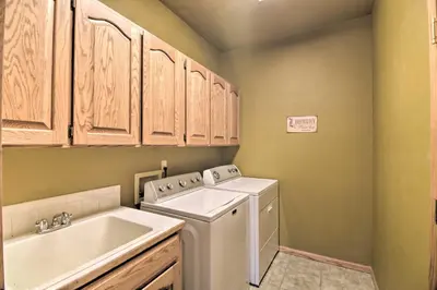 a laundry room with a washing machine and a sink at Charming Home with Yard about 12 Mi to Fort Collins in Loveland