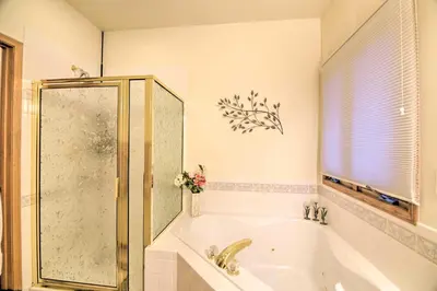 a bathroom with a bath tub and a shower at Charming Home with Yard about 12 Mi to Fort Collins in Loveland