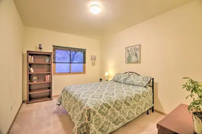 a bedroom with a bed and a book shelf at Charming Home with Yard about 12 Mi to Fort Collins in Loveland