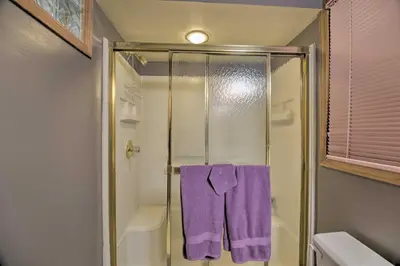 a bathroom with a shower with a purple towel at Charming Home with Yard about 12 Mi to Fort Collins in Loveland