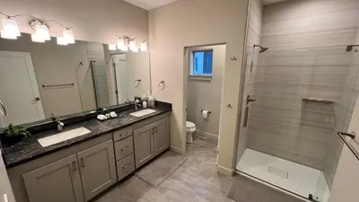 a bathroom with two sinks and a shower at 3BD/3BA- Updated Cozy Ski Retreat with Garage at the Base of Granby Ranch in Granby