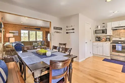 a dining room and kitchen with a table and chairs at Walk to Water Grand Lake Home with Hot Tub! in Grand Lake