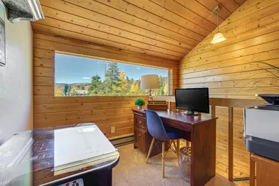 a room with a desk with a computer and a window at Walk to Water Grand Lake Home with Hot Tub! in Grand Lake
