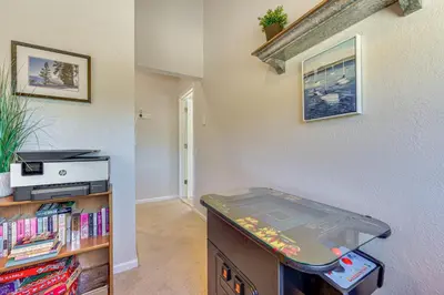 a room with a table with a video game at Walk to Water Grand Lake Home with Hot Tub! in Grand Lake