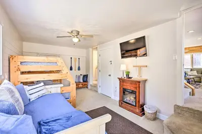 a living room with a couch and a fireplace at Walk to Water Grand Lake Home with Hot Tub! in Grand Lake