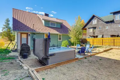 a backyard with a hot tub and a house at Walk to Water Grand Lake Home with Hot Tub! in Grand Lake
