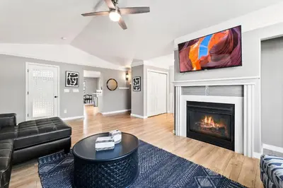 a living room with a couch and a fireplace at Scandinavian Chic - Hot Tub, Bikes and Lake Life! in Loveland