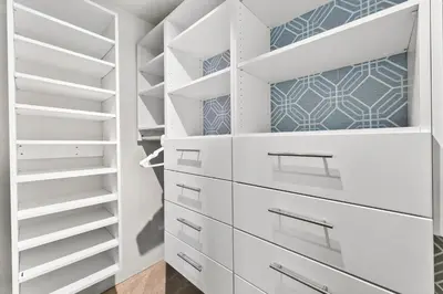 a white walk in closet with white drawers at Scandinavian Chic - Hot Tub, Bikes and Lake Life! in Loveland