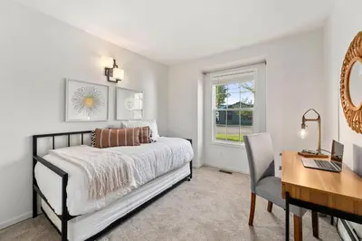 a bedroom with a bed and a desk and a computer at Scandinavian Chic - Hot Tub, Bikes and Lake Life! in Loveland
