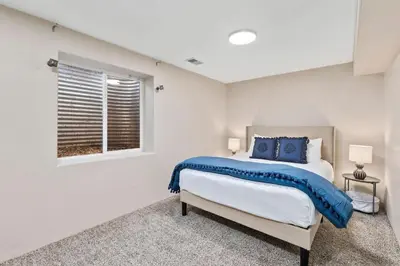 a bedroom with a bed and a window at Scandinavian Chic - Hot Tub, Bikes and Lake Life! in Loveland