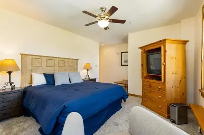 a bedroom with a bed and a ceiling fan at Three-Bedroom Apartment in Keystone