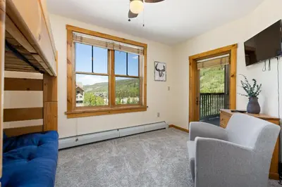a living room with a blue couch and a window at Three-Bedroom Apartment in Keystone