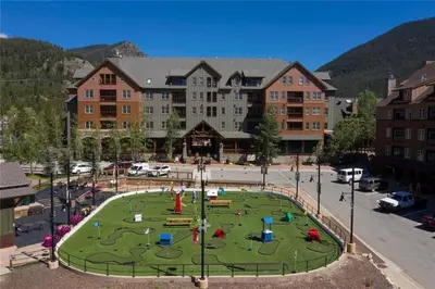 a large building with a playground in the middle of a park at Three-Bedroom Apartment in Keystone