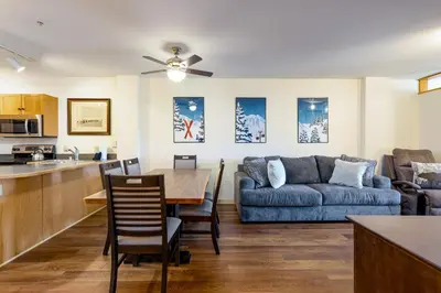 a kitchen and living room with a table and a couch at Three-Bedroom Apartment in Keystone