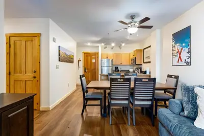 a dining room and kitchen with a table and chairs at Three-Bedroom Apartment in Keystone