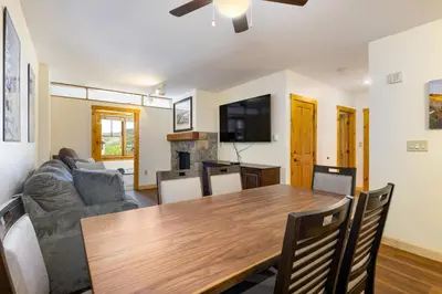 a living room with a table and a couch at Three-Bedroom Apartment in Keystone