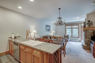 a kitchen with a sink and a living room at One-Bedroom Apartment in Dillon