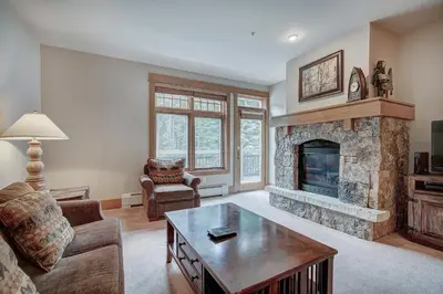 a living room with a fireplace and a table at One-Bedroom Apartment in Dillon