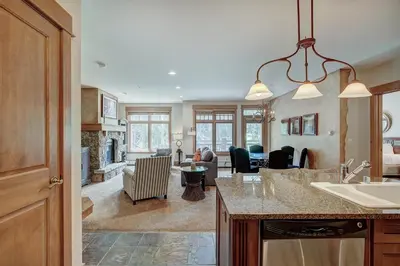 a kitchen and living room with a counter and a living room at Luxurious 2 BR in River Run Village with Ski in ski out, Kids Ski Free condo in Dillon