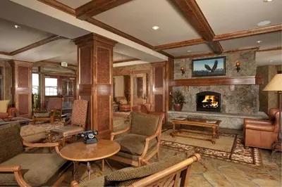 a living room filled with furniture and a fireplace at Luxurious 2 BR in River Run Village with Ski in ski out, Kids Ski Free condo in Dillon