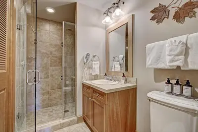 a bathroom with a shower and a sink and a toilet at Luxury 3 BR in River Run Village Featuring Ski in, ski out! condo in Dillon