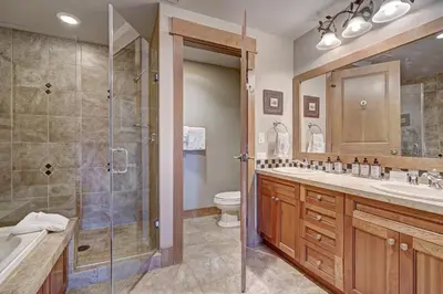 a bathroom with a shower and a sink and a toilet at Luxury 3 BR in River Run Village Featuring Ski in, ski out! condo in Dillon
