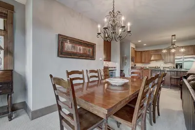 a dining room with a wooden table and chairs at Luxury 3 BR in River Run Village Featuring Ski in, ski out! condo in Dillon