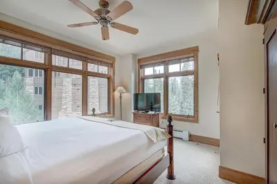 a bedroom with a bed and a ceiling fan at Luxurious 3 BR in River Run Village with Ski-In Out condo in Dillon