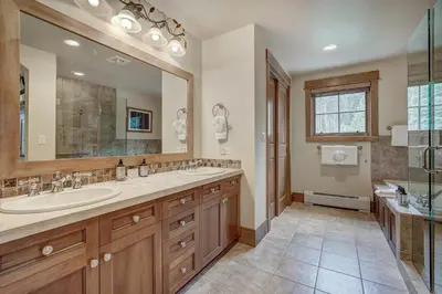 a bathroom with a sink and a large mirror at Luxurious 3 BR in River Run Village with Ski-In Out condo in Dillon