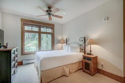 a bedroom with a bed with a ceiling fan and a window at Luxurious 3 BR in River Run Village with Ski-In Out condo in Dillon