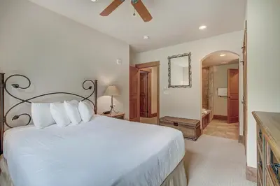 a bedroom with a large white bed and a bathroom at Luxurious 3 BR in River Run Village with Ski-In Out condo in Dillon