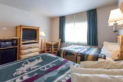 a hotel room with two beds and a television at North Park Inn & Suites in Walden