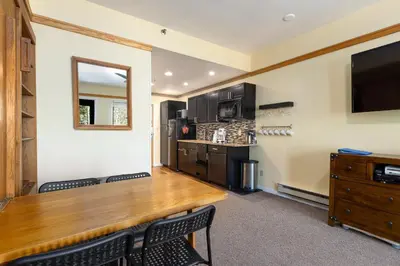 a conference room with a wooden table and a tv at 2767 Slopeside condo in Keystone