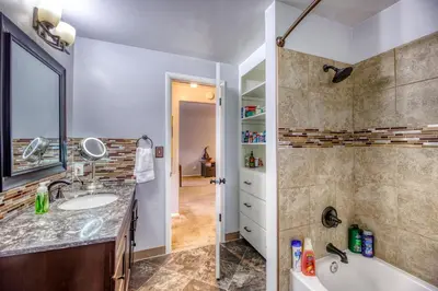 a bathroom with a tub and a sink and a shower at Quiet Sunlit Retreat w many Travel Amenities n Grg in Lakewood