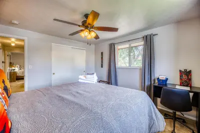 a bedroom with a bed and a ceiling fan at Quiet Sunlit Retreat w many Travel Amenities n Grg in Lakewood