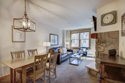 a living room with a table and a dining room at 1 Bedroom Mountain Condo In River Run Village With Expansive Mountain Views And Walking Distance To Ski Slopes in Keystone