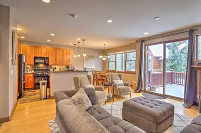 a living room with a couch and a kitchen at 5 Mi to Breckenridge Skiing Mtn Gem with Hot Tub! in Breckenridge