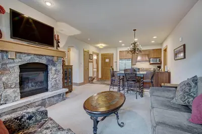 a living room with a fireplace and a tv at Luxurious 1 BR in River Run Village with Ski in ski out condo in Dillon