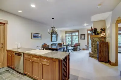 a kitchen and living room with a sink and a table at Luxurious 1 BR in River Run Village with Ski in ski out condo in Dillon