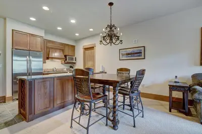 a kitchen with a wooden table and chairs at Luxurious 1 BR in River Run Village with Ski in ski out condo in Dillon