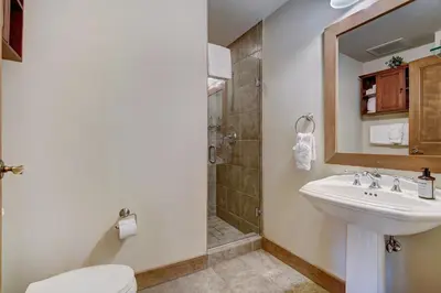 a bathroom with a toilet and a sink and a shower at Luxurious 1 BR in River Run Village with Ski in ski out condo in Dillon