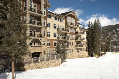 a large apartment building in the snow with trees at Luxurious 1 BR in River Run Village with Ski in ski out condo in Dillon