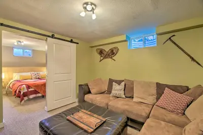 a living room with a couch and a bed at Patio, Grill and Yard Cozy Denver Abode! in Denver