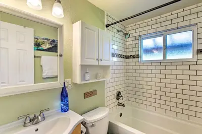 a bathroom with a sink and a toilet and a mirror at Patio, Grill and Yard Cozy Denver Abode! in Denver