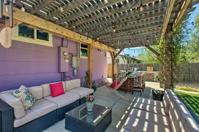 a patio with a white couch under a pergola at Patio, Grill and Yard Cozy Denver Abode! in Denver