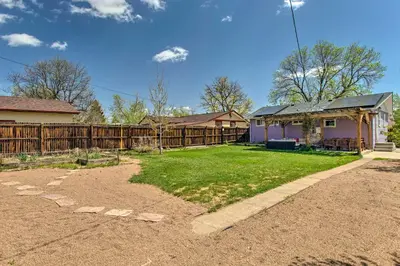 a yard with a fence and a house at Patio, Grill and Yard Cozy Denver Abode! in Denver