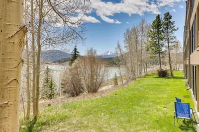 a yard with a blue chair on the side of a building at Mtn and Reservoir Views Cozy Dillon Condo! in Dillon