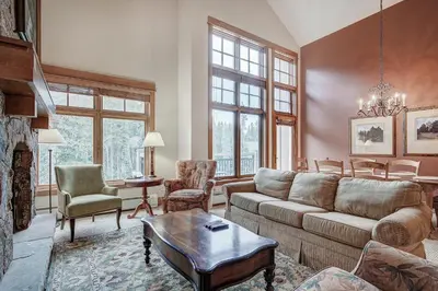 a living room with a couch and a fireplace at Luxurious 2 BR in River Run Village with Ski in ski out condo in Dillon