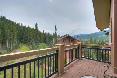 a balcony with a view of a house at Luxurious 2 BR in River Run Village with Ski in ski out condo in Dillon